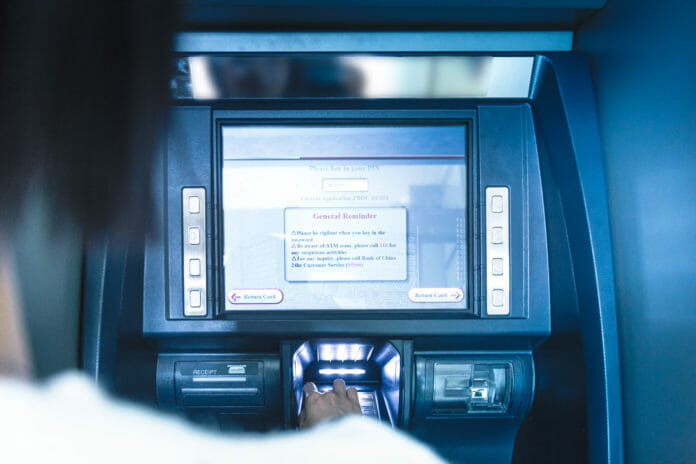 Woman using cash machine-ATM,close up view